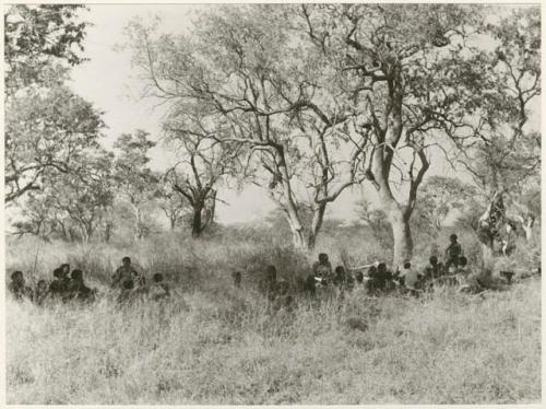 "Groups, Misc. and visitors": Groups of people sitting under trees (print is a cropped image)