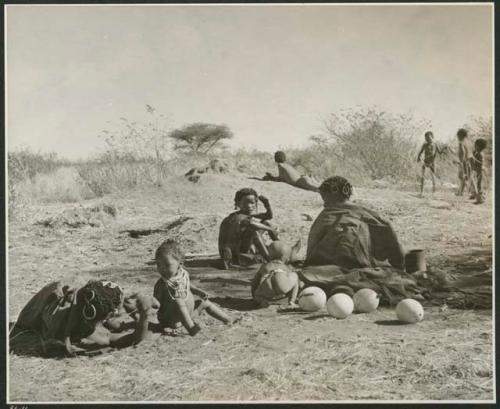 "Groups that show living place 'homes'": Group of women and children sitting and lying down (print is a cropped image)