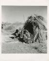 "Band 2, //Ao #44" & family": //Ao (son of "Old ≠Toma") and his wife ≠Nisa sitting in front of their skerm (print is a cropped image)