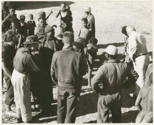 Family in Nai Nai: Expedition members greeted by a group of Ju/'hoansi (print is a cropped image)