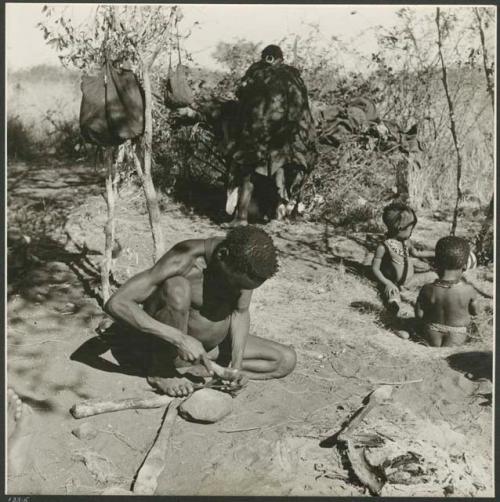 [No folder title]: "Gao Helmet" hammering and shaping an assegai blade with a piece of metal (print is a cropped image)