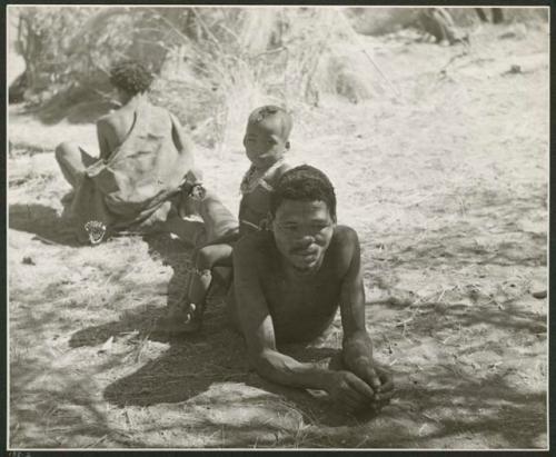 [No folder title]: "Gao Medicine" lying down, with his son, /Gaishay, sitting on his back (print is a cropped image)