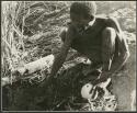 [No folder title]: "Old /Gaishay" of Band 4 filling his ostrich eggshell with water (print is a cropped image)