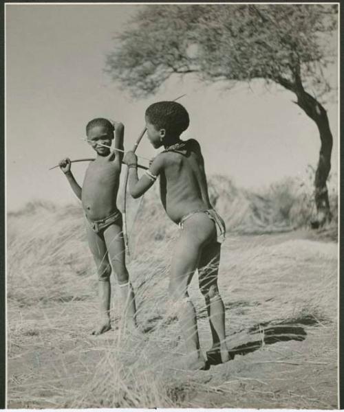 [No folder title]: Two boys standing and holding bows and arrows (print is a cropped image)