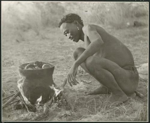 [No folder title]: Bo (brother of /Naoka, first wife of "Gao Medicine") cooking meat in an Ovambo pot (print is a cropped image)