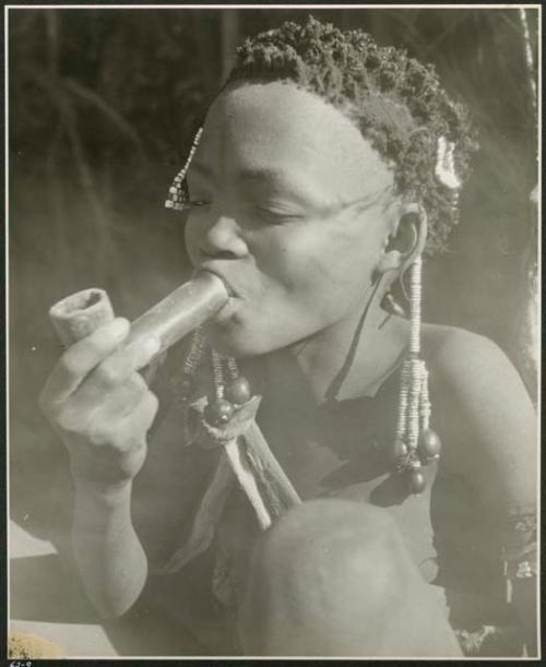 [No folder title]: Bau smoking a soapstone pipe (print is a cropped image)