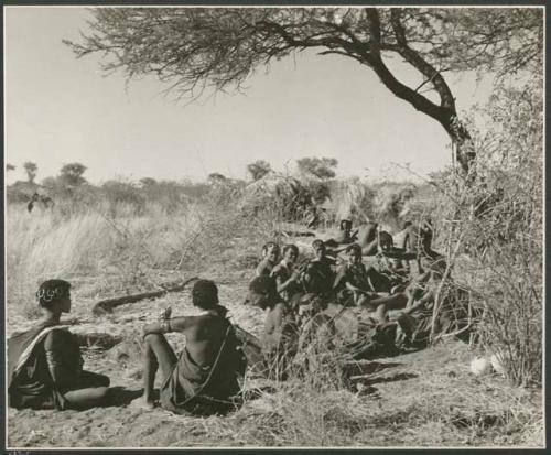 [No folder title]: "Gao Helmet" sitting his extended family and relatives, including Khuan//a of Band 4, Khwo//o-/Gasa and her husband ≠Gao with their daughter //Kushay, /Gasa, //Khuga, "Old /Gam," Xama, //Kushay ("Gao Helmet's" first wife), /Tuka, and ≠Toma  (print is a cropped image)