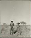 [No folder title]: "Old Gau" holding a spring-hare hook, with a boy standing next to him (print is a cropped image)