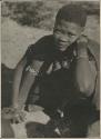 Girl seated and looking up into camera