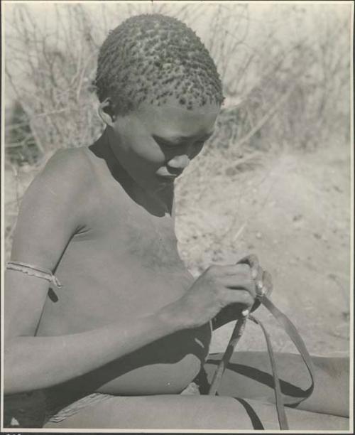 Gau's son holding a slingshot made from a piece of an old inner tube