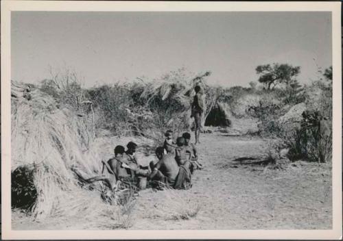 "Gao Medicine" bringing a quarter of meat in meat distribution to a group of people in Band 2 sitting in front of Gau's skerm