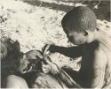 !Gai seated, cutting another man's hair, close-up



