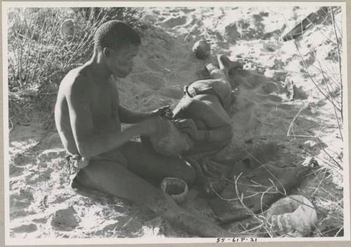 !Gai seated, cutting another man's hair



