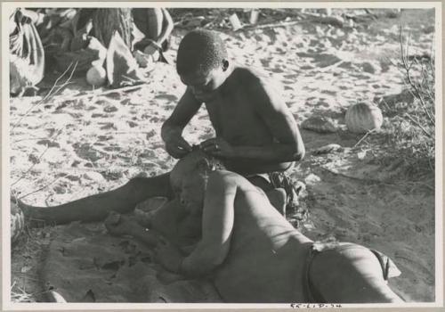 !Gai seated, cutting another man's hair



