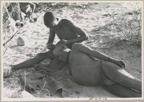 !Gai seated, cutting another man's hair





