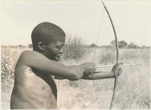 !Gai demonstrating shooting an arrow, half figure