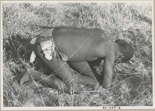 Boys tussling in grass


