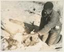 Philip Hameva cooking springbok joint wrapped in a hide