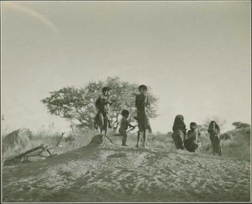 Children dancing on an anthill



