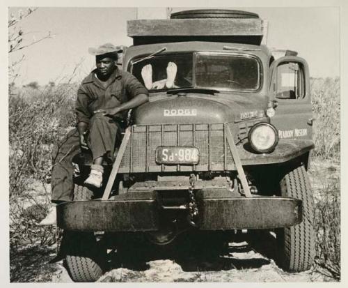 Kernel Ledimo sitting on the front left wheel of the expedition power wagon