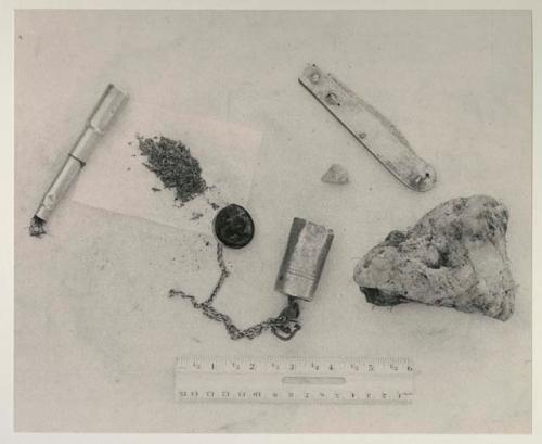 Pipe, tobacco, fire-striker and stone to make a spark, metal knife and fungus used as tinder, with a ruler for measurement