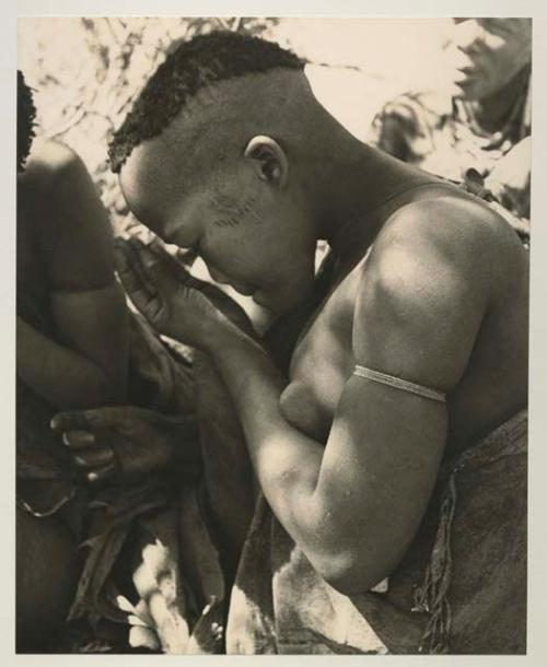 Woman visiting from Okwa, profile, close-up showing her haircut and scarification
