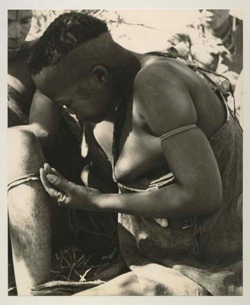 Woman visiting from Okwa, profile, close-up showing her haircut and scarification

