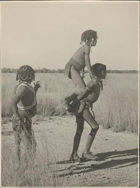 Three girls playing a game at the edge of Gautscha Pan (print is a cropped image)