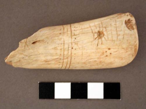 Bone, shaft fragment, broken at one end and rounded at other, incised decoration