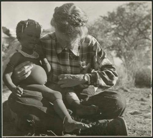 [No folder title]: /Khoa (daughter of /Qui and /Naoka) sitting in Lorna Marshall's lap (print is a cropped image)