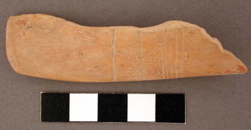 Bone, shaft, split, polished and worked, incised and punctate decoration.