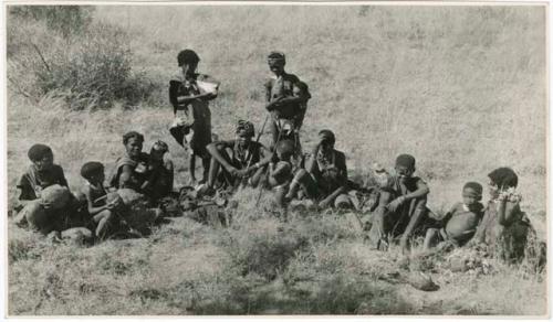 [No folder title]: Group of women of /Ti!kay's group sitting, with the veldkos they have gathered in front of them (print is a cropped image)