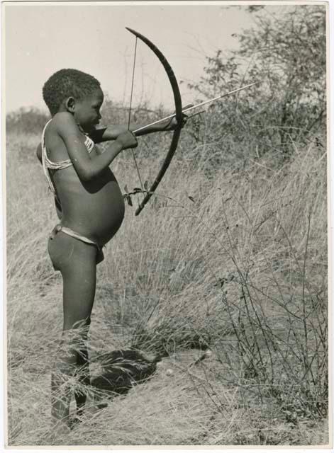 "Boys playing at hunting": Boy shooting with a bow and arrow (print is a cropped image)