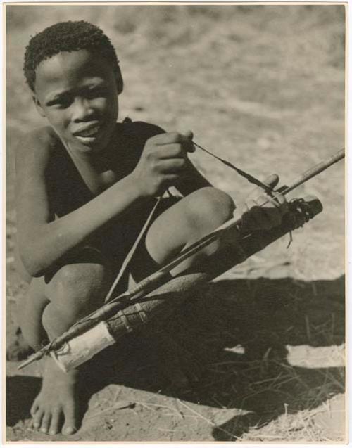 "Boys playing at hunting": /Gishay (son of "Old Gau") squatting and holding a quiver and bow (print is a cropped image)