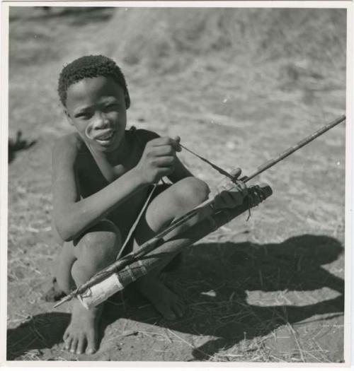 "Boys playing at hunting": /Gishay (son of "Old Gau") squatting and holding a quiver and bow (print is a cropped image)