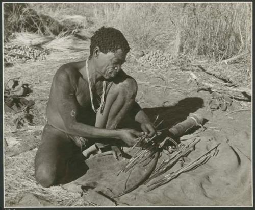 [No folder title]: "Old Gau" with his bow and arrows, and quiver on the ground in front of him (print is a cropped image)