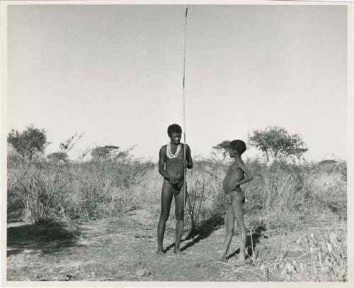 "Spring hare prodder": "Old Gau" holding a spring-hare hook, with a boy standing next to him (print is a cropped image)