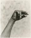 "The hunting hand signs": Person's hand demonstrating hunting signals (print is a cropped image)