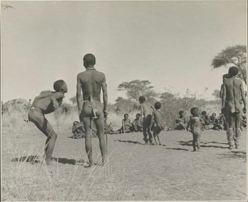 Group of men performing a curing dance