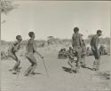 Group of men performing a curing dance