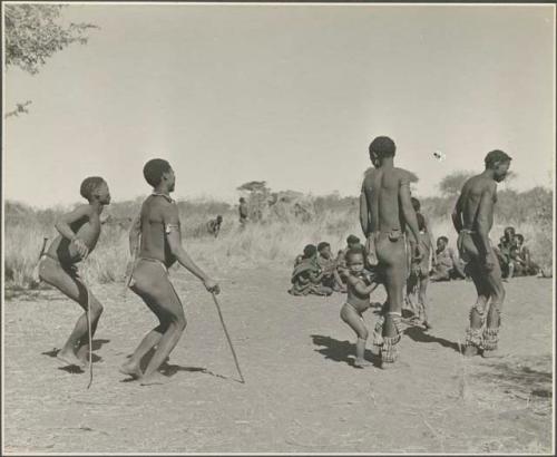 Group of men performing a curing dance