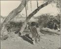 Children from "Gao Helmet's" group standing beside a net and rattles hanging from a tree