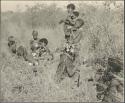 Group of women and girls digging for roots

