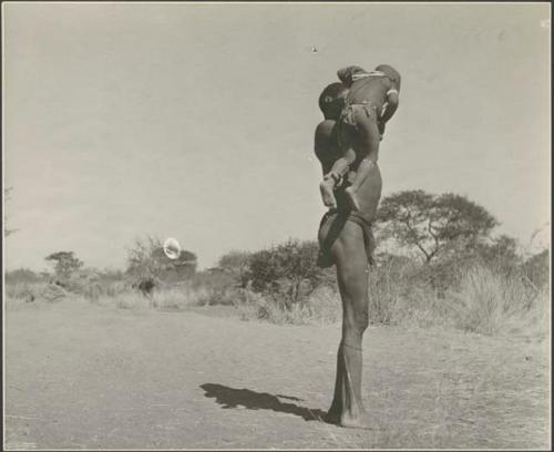 "Gao Medicine" lifting his son /Gaishay up to his shoulder
