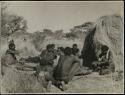 Group of women rolling cord seated in front of a skerm