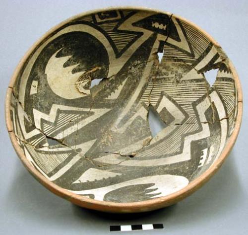 Gila polychrome bowl. hemispherical, rounded base; 2 perforations near rim. interior black on white, exterior red slip. fireclouds