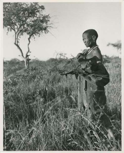 [No folder title]: "Old /Gasa" holding a wildebeest head (print is a cropped image)