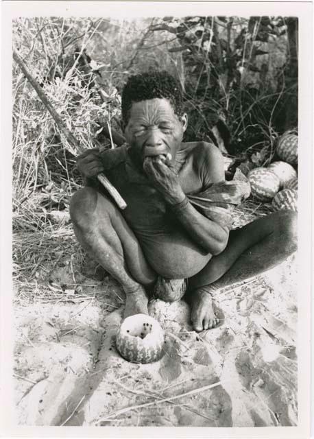 "With tsama": Oukwane eating a tsama melon (print is a cropped image)