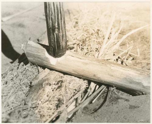 "Firemaking': Sticks held in position for fire making (print is a cropped image)