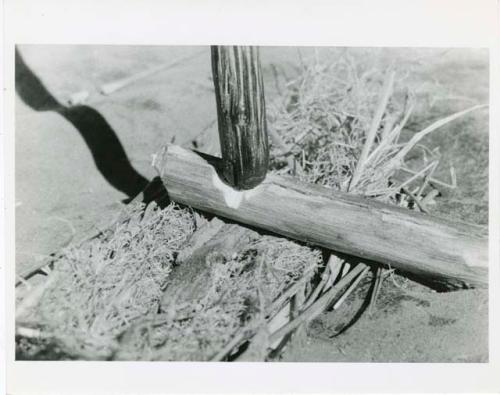 "Firemaking": Sticks held in position for fire making (print is a cropped image)